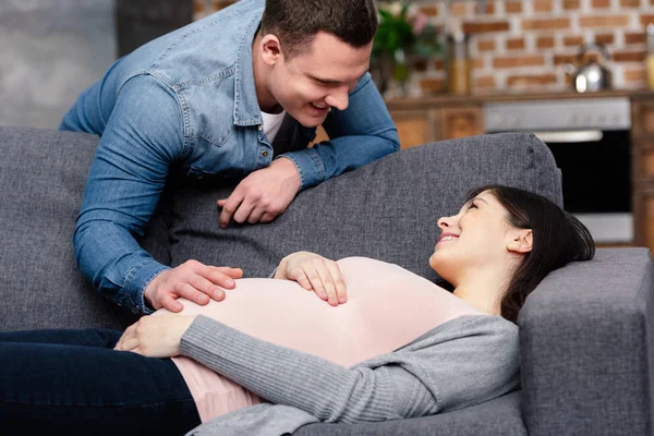 Happy Young Pregnant Woman Lying Sofa Looking Smiling Husband Home — Stock Photo, Image