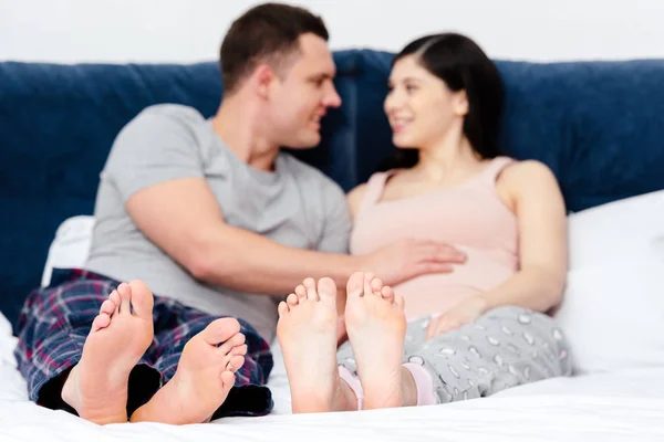 Happy Young Pregnant Couple Smiling Each Other Bed — Stock Photo, Image