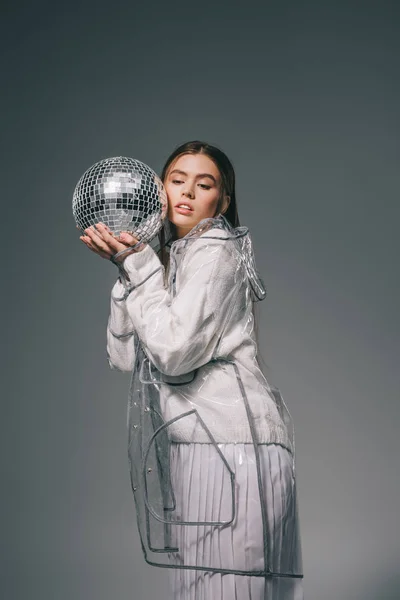 Portrait Young Woman Fashionable Raincoat Disco Ball Isolated Grey — Free Stock Photo