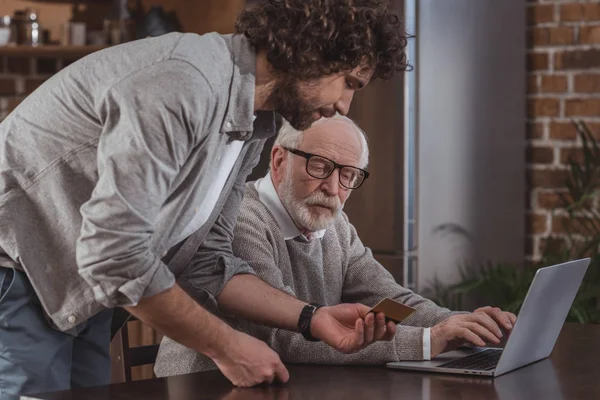 Zijaanzicht Van Volwassen Zoon Beschrijven Senior Vader Hoe Winkelen Online — Stockfoto