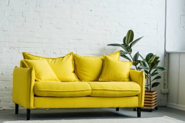 Modern light room interior with yellow sofa clipart