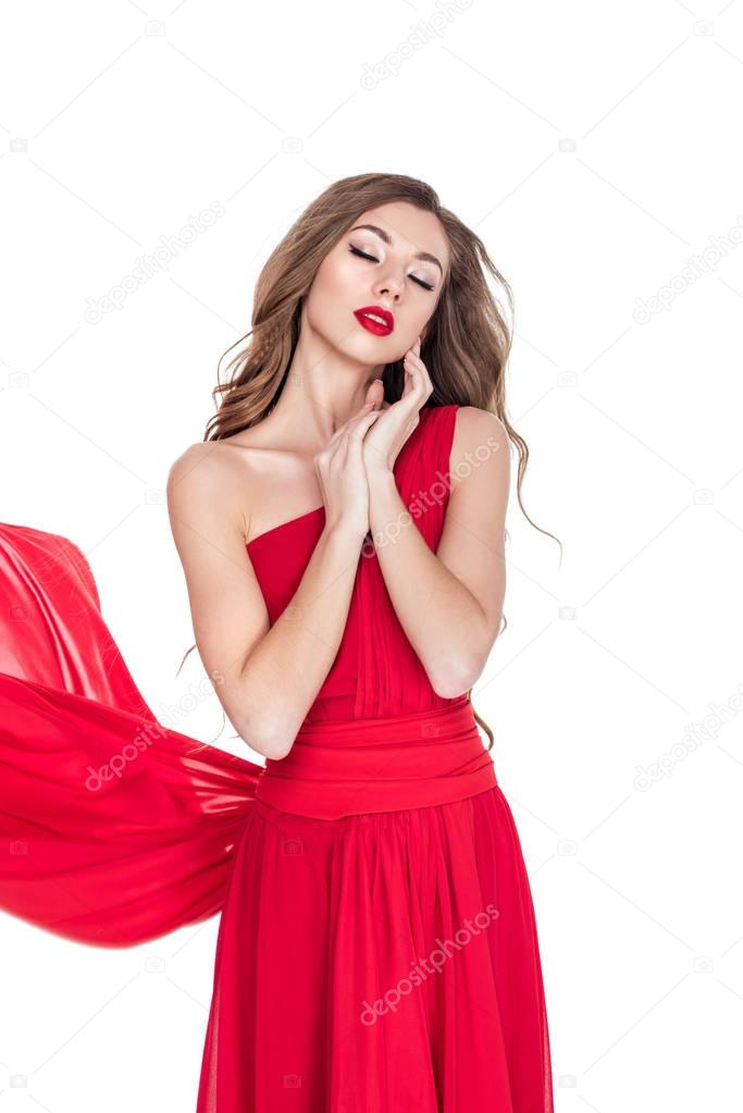 sensual girl with closed eyes posing in red dress, isolated on white