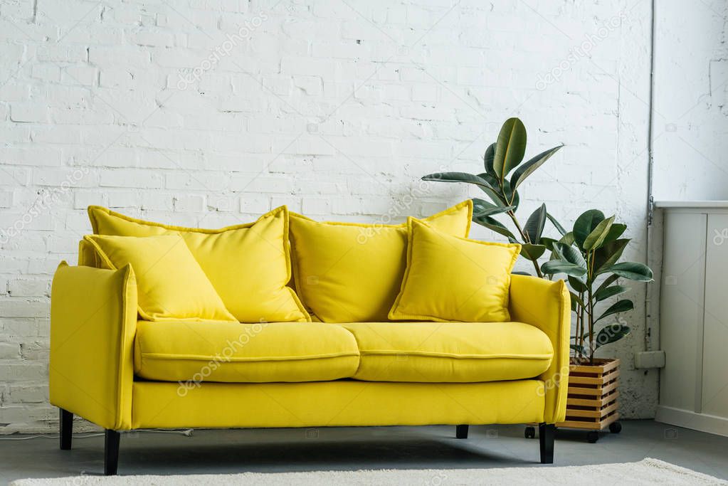 Modern light room interior with yellow sofa