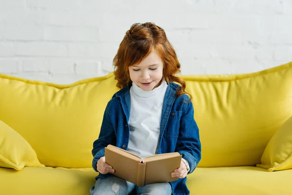 Enthusiastic Little Child Reading Book Sofa — Stock Photo, Image