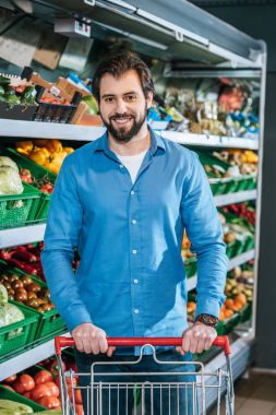 adam bakkal dükkanı alışveriş sepeti ile gülümseyen portresi