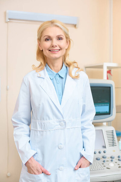 happy female doctor looking at camera at ultrasound screening office