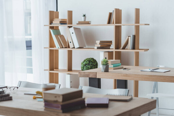 classroom interior with shelf and books on tables