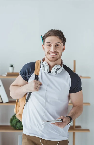 Cheerful Student Headphones Backpack Notebook — Free Stock Photo