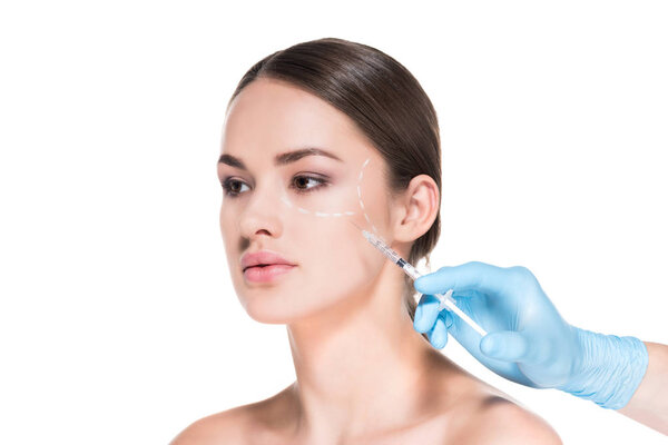 cropped shot of doctor making beauty injection for young woman while she looking away isolated on white