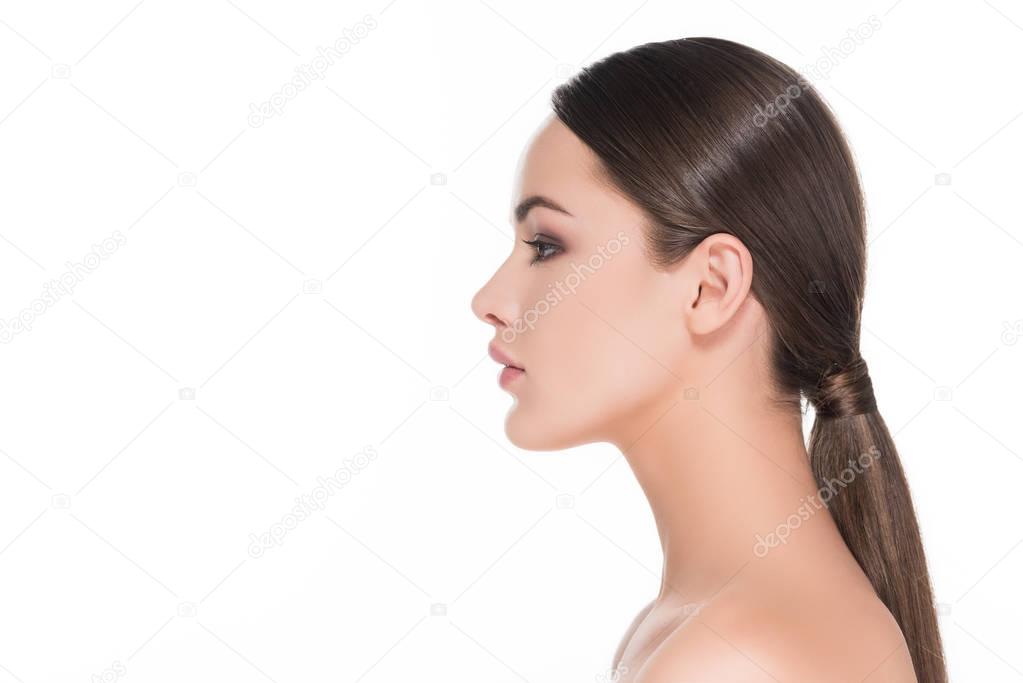 side view of beautiful young woman with pony tail isolated on white