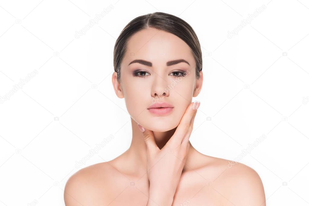 young woman touching her chin and looking at camera isolated on white