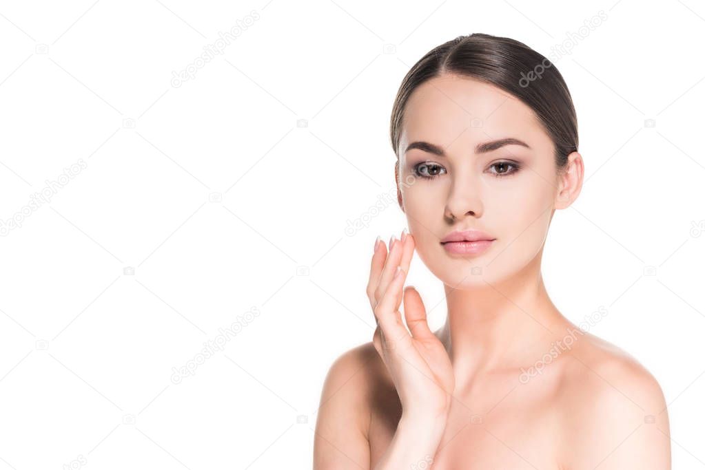 beautiful young woman applying moisturizing cream on face isolated on white