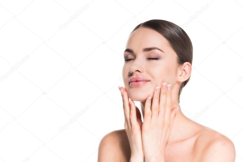 smiling young woman touching her face with eyes shut isolated on white