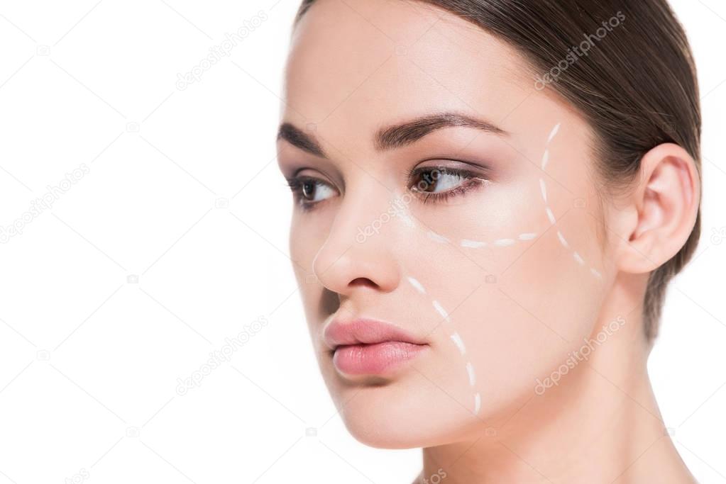beautiful young woman with dotted line drawn on face for plastic surgery isolated on white