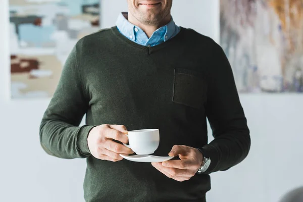 Smiling Man Holding Cup Coffee His Hands — Free Stock Photo