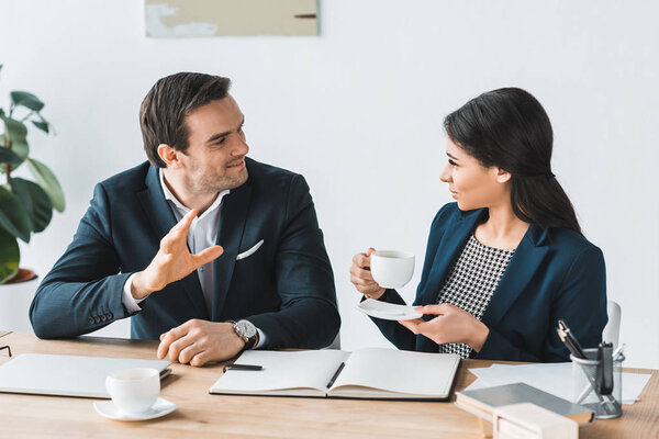 Businessman and businesswoman having a discussion about project in modern office