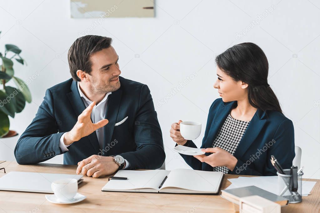 Businessman and businesswoman having a discussion about project in modern office