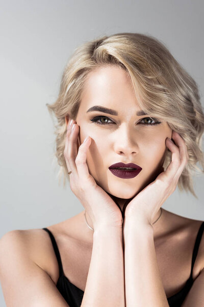 portrait of attractive blonde girl with makeup, isolated on grey 