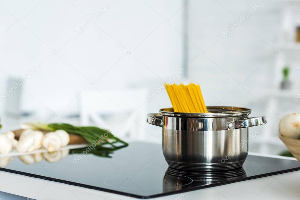 pan with pasta on clean electric stove in kitchen