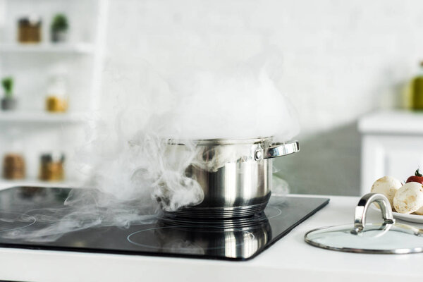 steam over pan on electric stove in kitchen