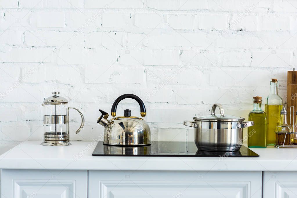 kettle and pan on electric stove in kitchen