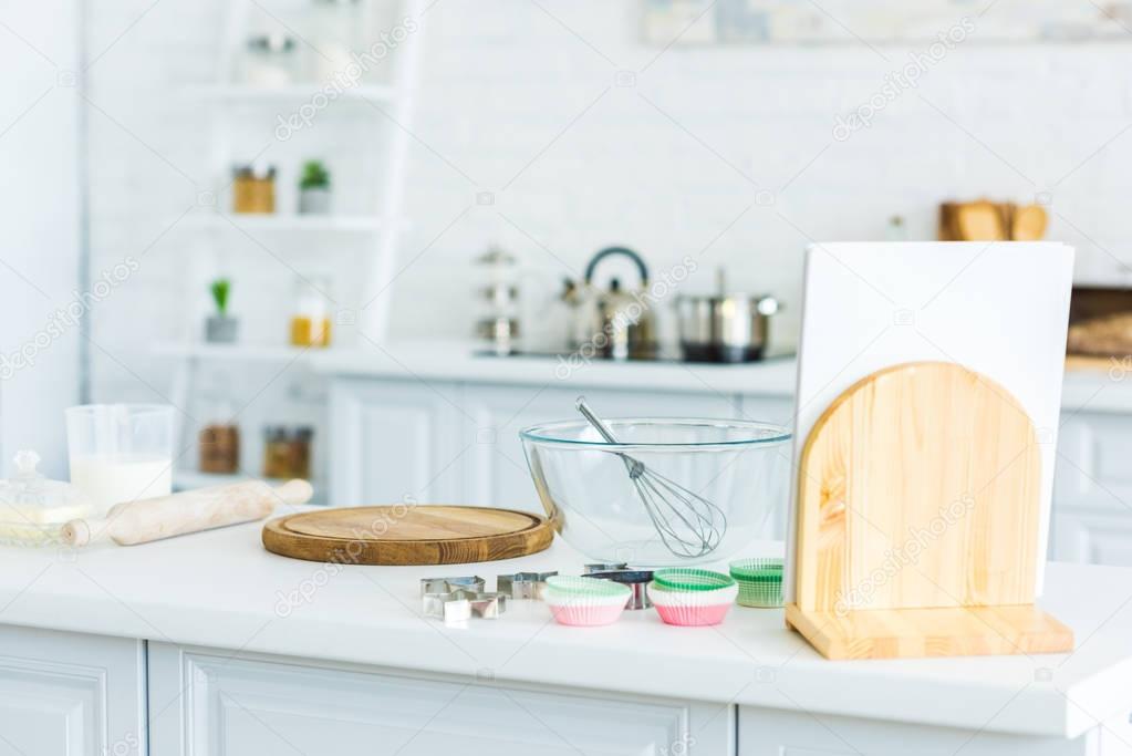 cutting board and bowl with whisk on kitchen counter