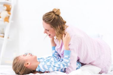 mutlu anne ve eğleniyor ve yatağa evde oynarken kızı