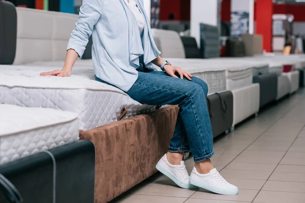 Sitting on mattress in furniture store — Stock Photo, Image