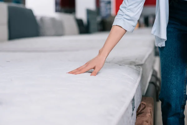 Touching orthopedic mattress — Stock Photo, Image