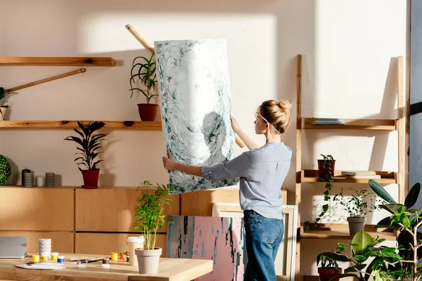 Young Female Artist Paintbrush Ear Taking Canvas Studio — Stock Photo, Image
