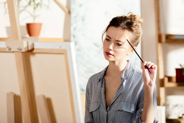 Female Artist Paintbrush Looking Canvas Studio — Stock Photo, Image
