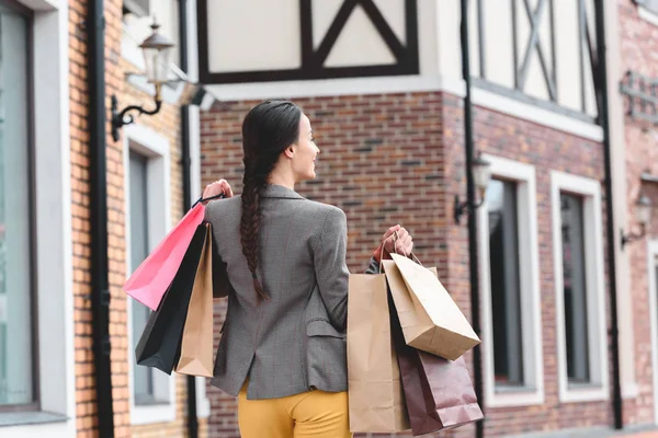 Back View Woman Walking Shopping Bags — Free Stock Photo