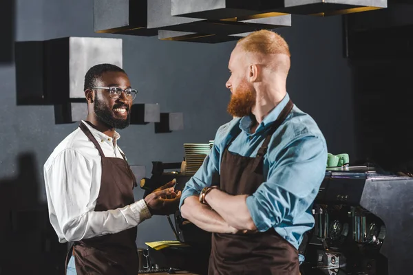 Smiling Multiethnic Owners Coffee Shop Aprons Talking Coffee Shop — Stock Photo, Image