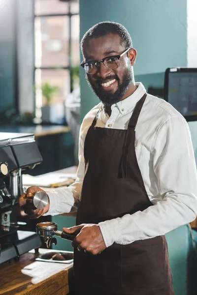 Joven Africano Americano Barista Gafas Sonriendo Cámara Mientras Haciendo Café — Foto de stock gratis