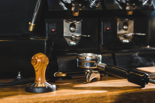close-up view of modern coffee machine on wooden table in coffee shop