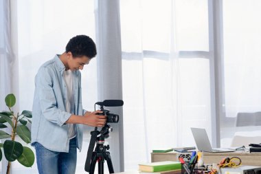 Afrikalı-Amerikalı genç ayarı fotoğraf makinesi için video blog evde av