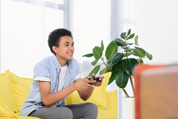 Having Fun at Home. Cheerful Black Teen Guy with Joystick Playing Online  Computer Games, Sitting on Couch Indoors Stock Image - Image of computer,  person: 227478857