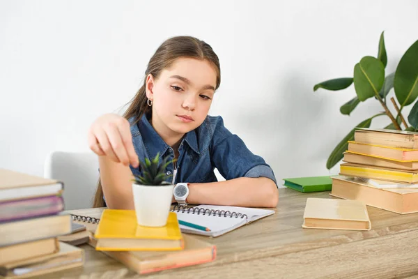 Adorable Preteen Child Touching Potted Plant Table Books Home — Stock Photo, Image