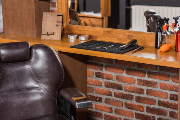 barber chair and tools on counter at barbershop