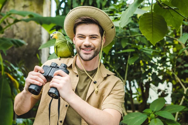 Happy Young Man Parrot Shoulder Binoculars Looking Camera — Stock Photo, Image