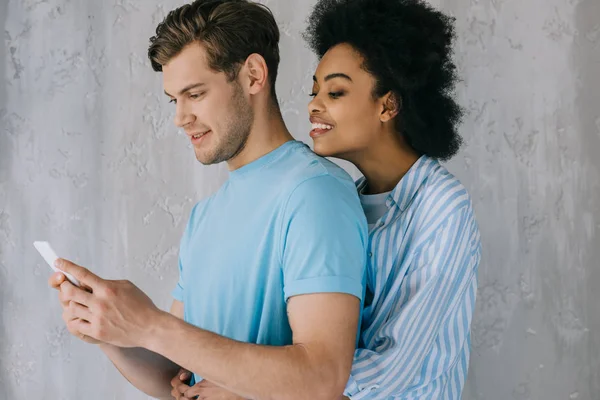 African American Girlfriend Embracing Young Man Phone Hands — Stock Photo, Image