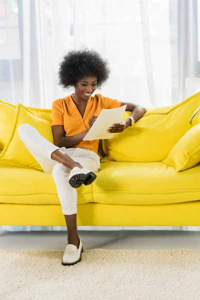 Smiling African American Woman Papers Remote Working Sofa Home — Stock Photo, Image