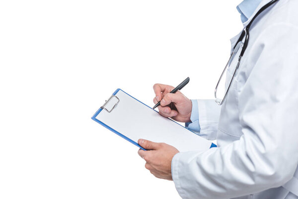 cropped image of male doctor writing diagnosis in clipboard isolated on white background