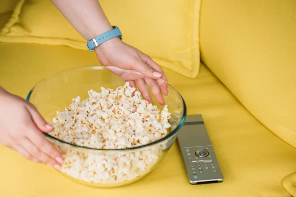 Cropped Image Woman Putting Bowl Popcorn Sofa Home — Stock Photo, Image