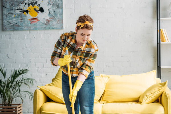 attractive woman cleaning with mop at home