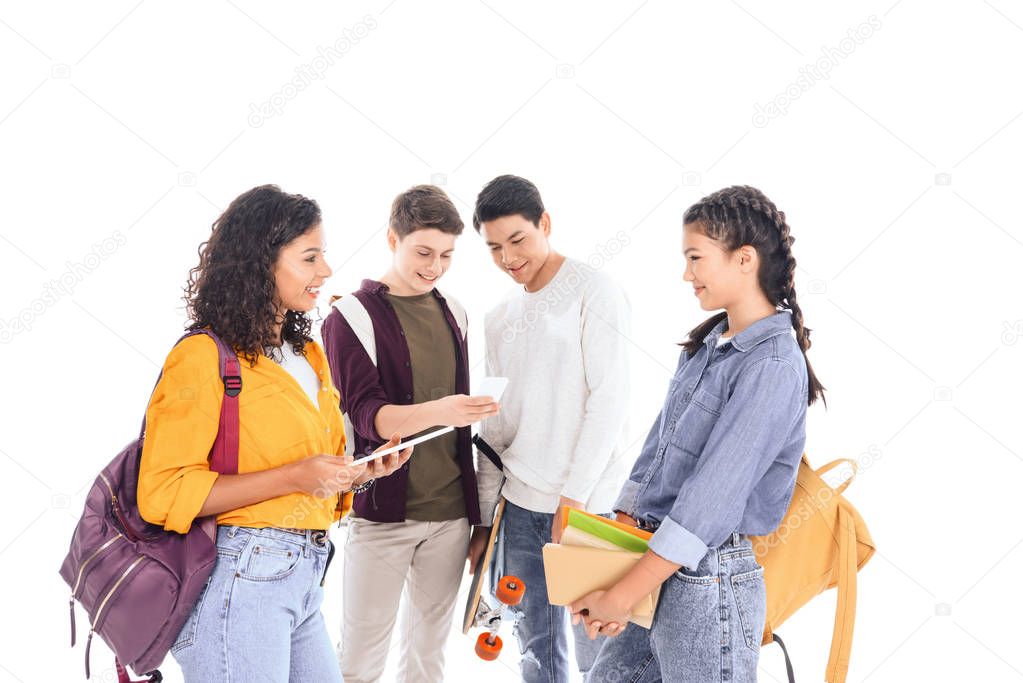 multiracial students with backpacks, digital devices and notebooks isolated on white