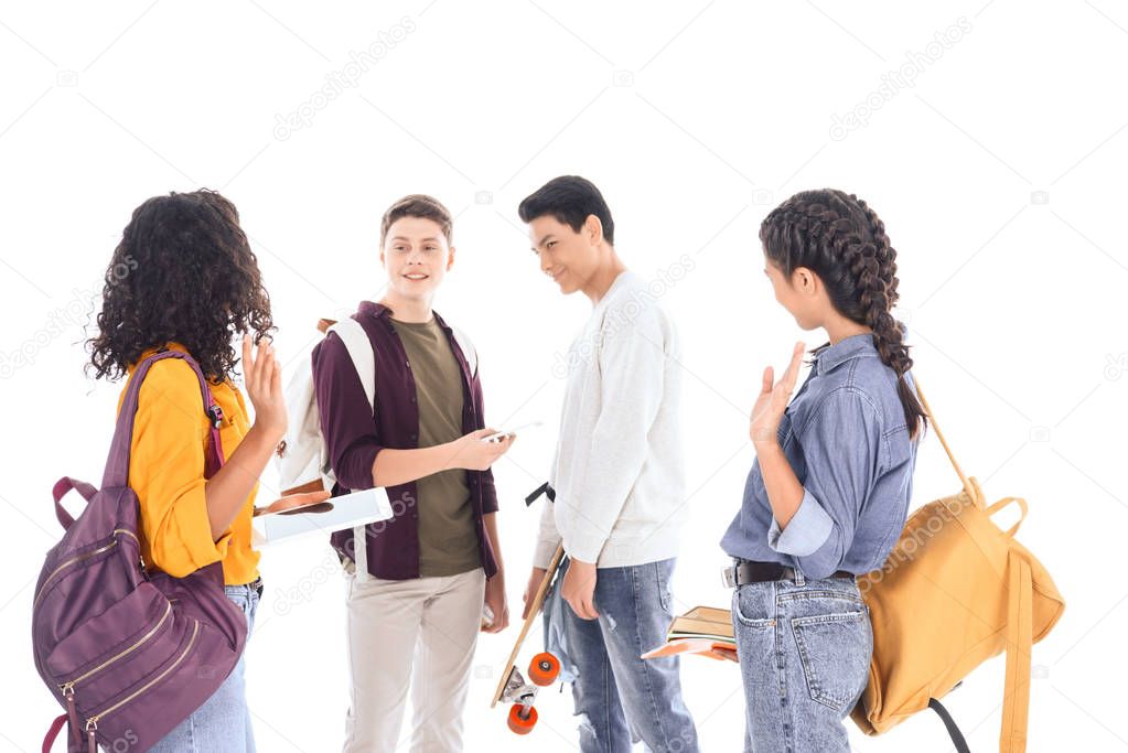 multiracial students with backpacks, digital devices and notebooks isolated on white