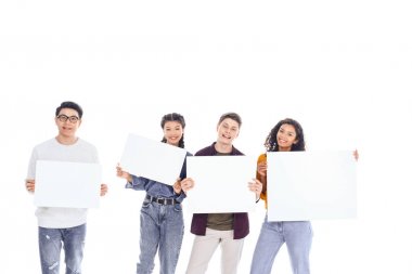 portrait of interracial teenagers holding blank banners in hands isolated on white clipart