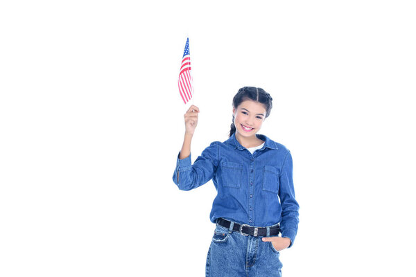 successful teenage student girl with usa flag in raised hand isolated on white