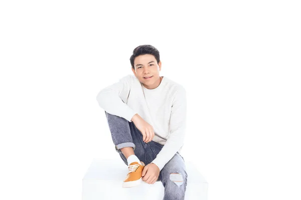 Teen Asian Student Boy Sitting White Cube Looking Camera Isolated — Stock Photo, Image